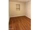 Simple bedroom with hardwood floors and built-in shelving at 469 W Newmont St, Superior, AZ 85173