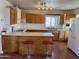 Kitchen with wood cabinets, an island, and hardwood floors at 469 W Newmont St, Superior, AZ 85173