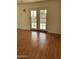 Living room with hardwood floors and French doors leading to patio at 469 W Newmont St, Superior, AZ 85173