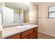 Bathroom boasts a vanity with mirror and shower/tub combo at 4723 W Gelding Dr, Glendale, AZ 85306