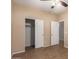 Bedroom with double door closet and ceiling fan at 4723 W Gelding Dr, Glendale, AZ 85306