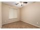 Bright bedroom with tile floors and ceiling fan at 4723 W Gelding Dr, Glendale, AZ 85306