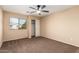 Bright bedroom with ceiling fan and carpet at 4723 W Gelding Dr, Glendale, AZ 85306