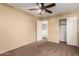 Bedroom with ceiling fan and access to upper level at 4723 W Gelding Dr, Glendale, AZ 85306