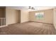 Spacious bedroom with carpeted floors and window at 4723 W Gelding Dr, Glendale, AZ 85306