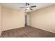 Spacious bedroom with ceiling fan and carpet at 4723 W Gelding Dr, Glendale, AZ 85306