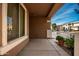 Covered front porch with tile flooring and potted plants at 4723 W Gelding Dr, Glendale, AZ 85306