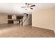 Open living room with tile floor, kitchen and staircase view at 4723 W Gelding Dr, Glendale, AZ 85306