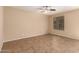 Spacious living room with tile flooring and ceiling fan at 4723 W Gelding Dr, Glendale, AZ 85306