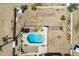 Overhead view of a refreshing blue pool with a yellow slide in a large backyard at 4832 W Saguaro Park Ln, Glendale, AZ 85310