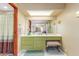 Bathroom with green vanity and a large mirror at 4832 W Saguaro Park Ln, Glendale, AZ 85310