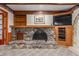 Stone fireplace with built-in shelving and entertainment center at 4832 W Saguaro Park Ln, Glendale, AZ 85310