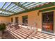 Covered patio with wrought iron gate and seating area at 4832 W Saguaro Park Ln, Glendale, AZ 85310