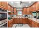 L-shaped kitchen with granite countertops and breakfast bar at 4832 W Saguaro Park Ln, Glendale, AZ 85310