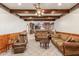 Spacious living room featuring comfortable seating and a view into the kitchen at 4832 W Saguaro Park Ln, Glendale, AZ 85310