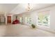 Open living room with large windows and chandelier at 4832 W Saguaro Park Ln, Glendale, AZ 85310