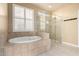 Spa-like bathroom with soaking tub, walk-in shower, and tile flooring at 4914 W Comanche Dr, Eloy, AZ 85131