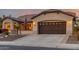 Tan house with a brown garage door and desert landscaping at 4914 W Comanche Dr, Eloy, AZ 85131