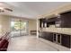 Wet bar with dark wood cabinets and wine cooler at 4914 W Comanche Dr, Eloy, AZ 85131