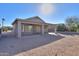 Covered patio with adjacent gravel backyard and a partial view of a fenced yard at 498 N Santiago Trl, Casa Grande, AZ 85194