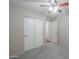 Bedroom with double doors and ceiling fan at 498 N Santiago Trl, Casa Grande, AZ 85194