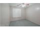 Bright bedroom with ceiling fan and window shutters at 498 N Santiago Trl, Casa Grande, AZ 85194