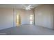 Well-lit bedroom with access to bathroom and hallway at 498 N Santiago Trl, Casa Grande, AZ 85194