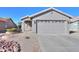 Single-story home with a two-car garage and well-maintained landscaping at 498 N Santiago Trl, Casa Grande, AZ 85194