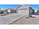 View of the home's exterior, showcasing the driveway and landscaping at 498 N Santiago Trl, Casa Grande, AZ 85194