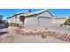 House exterior with a landscaped front yard and gravel driveway at 498 N Santiago Trl, Casa Grande, AZ 85194