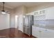 Kitchen with stainless steel refrigerator and white cabinets at 498 N Santiago Trl, Casa Grande, AZ 85194