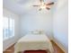 Bedroom with a ceiling fan, window with shutters, and hardwood floors at 602 N May St # 47, Mesa, AZ 85201