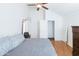 Bedroom with hardwood floors, large bed, and walk-in closet at 602 N May St # 47, Mesa, AZ 85201