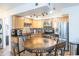 Kitchen features a round table and chairs, stainless steel appliances, and wood cabinets at 602 N May St # 47, Mesa, AZ 85201