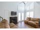 Bright living room with a fireplace, two sofas, and double doors leading to a patio at 602 N May St # 47, Mesa, AZ 85201