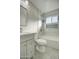 Updated bathroom with gray vanity, white marble tile, and bathtub at 6323 N 65Th Dr, Glendale, AZ 85301