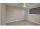 Spacious bedroom with ceiling fan, gray walls, and tile flooring at 6323 N 65Th Dr, Glendale, AZ 85301