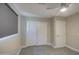 Bright bedroom featuring double door closet and ceiling fan at 6323 N 65Th Dr, Glendale, AZ 85301