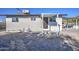 Rear view of house showing patio and gravel yard at 6323 N 65Th Dr, Glendale, AZ 85301