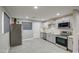 Modern kitchen with gray cabinets and stainless steel appliances at 6323 N 65Th Dr, Glendale, AZ 85301