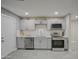 Modern kitchen featuring gray cabinets, stainless steel appliances, and white subway tile backsplash at 6323 N 65Th Dr, Glendale, AZ 85301