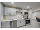 Modern kitchen with gray cabinets, white subway tile backsplash, and stainless steel appliances at 6323 N 65Th Dr, Glendale, AZ 85301