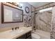 Bathroom with a shower/tub combo and marble-tiled walls at 6340 W Ironwood Dr, Glendale, AZ 85302