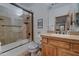 Bathroom with shower, tub and wood vanity at 6502 N 81St Pl, Scottsdale, AZ 85250