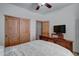 Bedroom with wood bed frame and doors at 6502 N 81St Pl, Scottsdale, AZ 85250