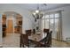 Bright dining room features a wood table with six chairs and a view into the kitchen at 6502 N 81St Pl, Scottsdale, AZ 85250