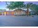 House exterior with a brick driveway and lush landscaping at 6502 N 81St Pl, Scottsdale, AZ 85250