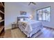 Bright bedroom with wood floors, plush bed, and large window at 7257 E Visao Dr, Scottsdale, AZ 85266