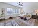 Main bedroom with plush bed, wood floors, and plantation shutters at 7257 E Visao Dr, Scottsdale, AZ 85266