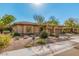 Charming home featuring a neutral stucco exterior, well-maintained desert landscaping, and a three-car garage at 7257 E Visao Dr, Scottsdale, AZ 85266